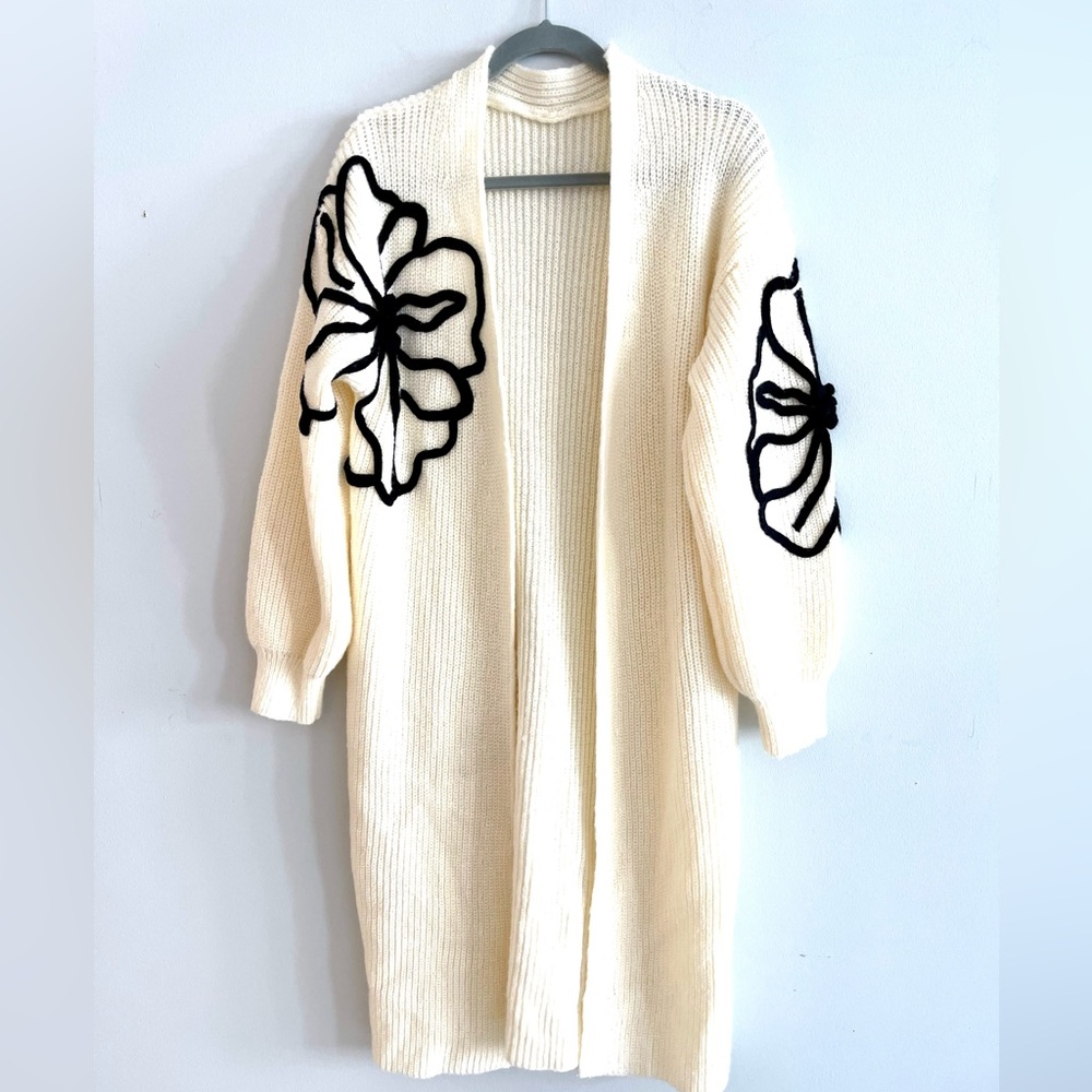 Elegant Cream Open-Front Sweater with Black Floral Design